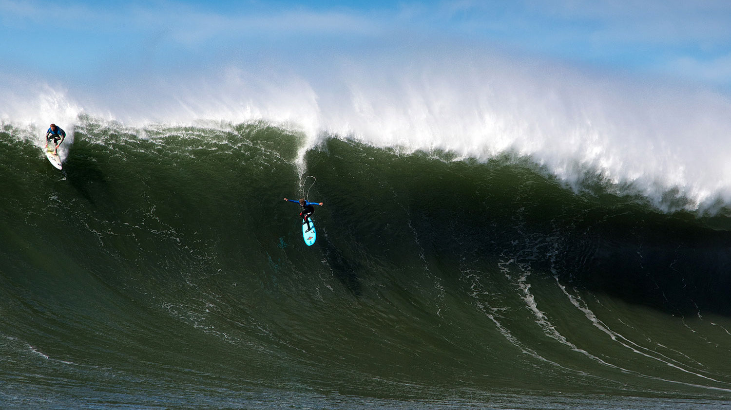 Matt Becker airdrops into a large wave surfing maverick’s.