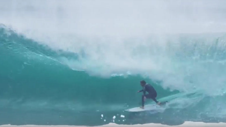 Mitch Crews surfing fast through a tube.