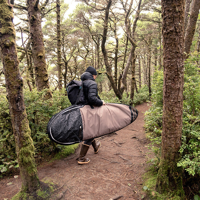 man carrying surfboard bag, surfboard travel bags
