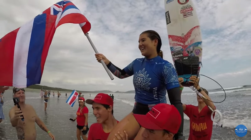 Brisa Hennessy holds costa rica flag after surf contest win.