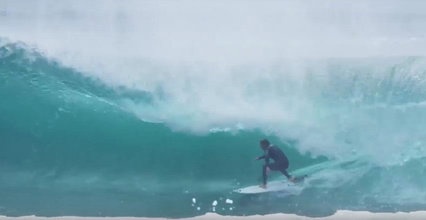Mitch Crews surfing fast through a tube.