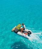 Surfer on boat with prolite surfboard day bag.