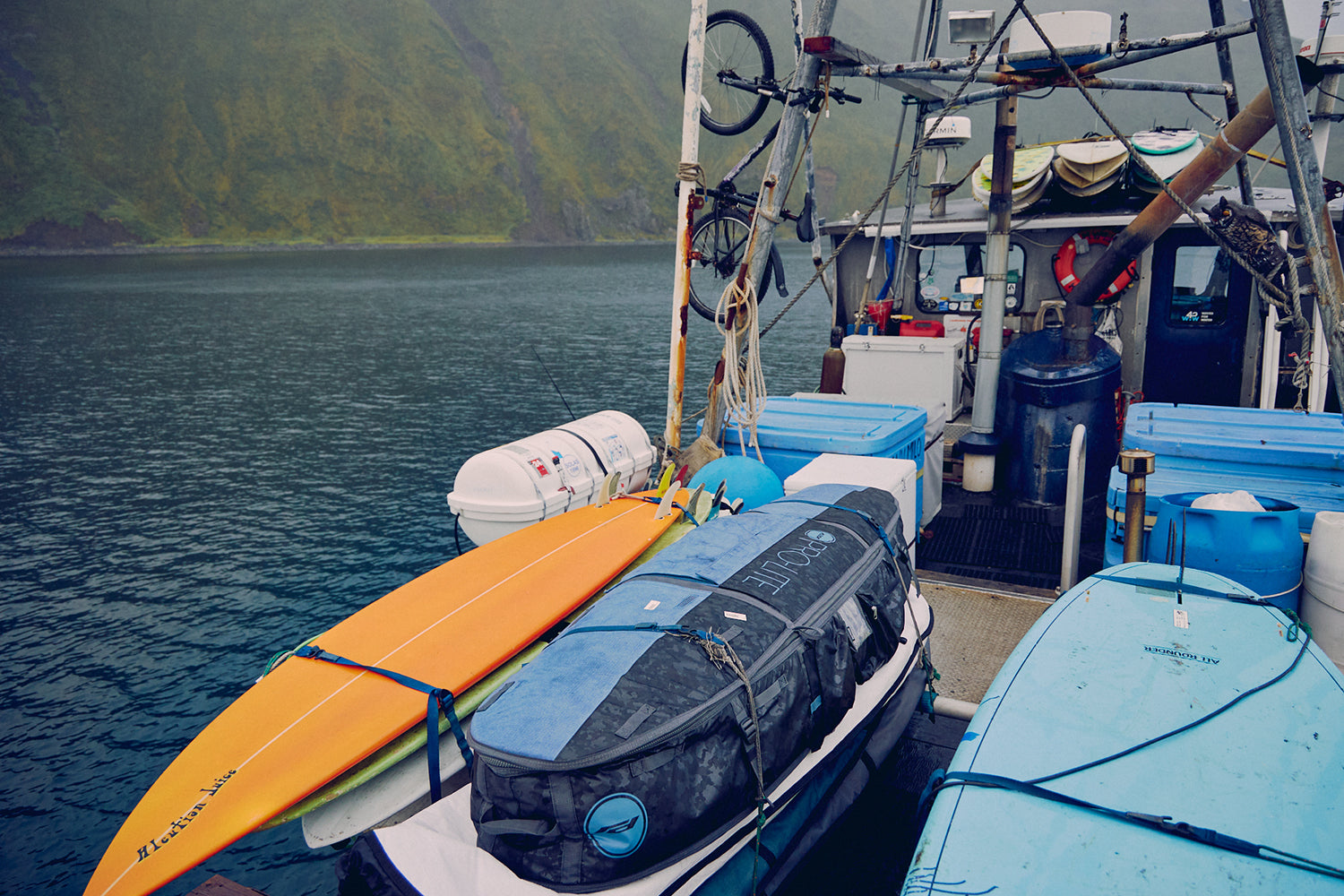 Armored coffin surfboard travel bag on boat alaska