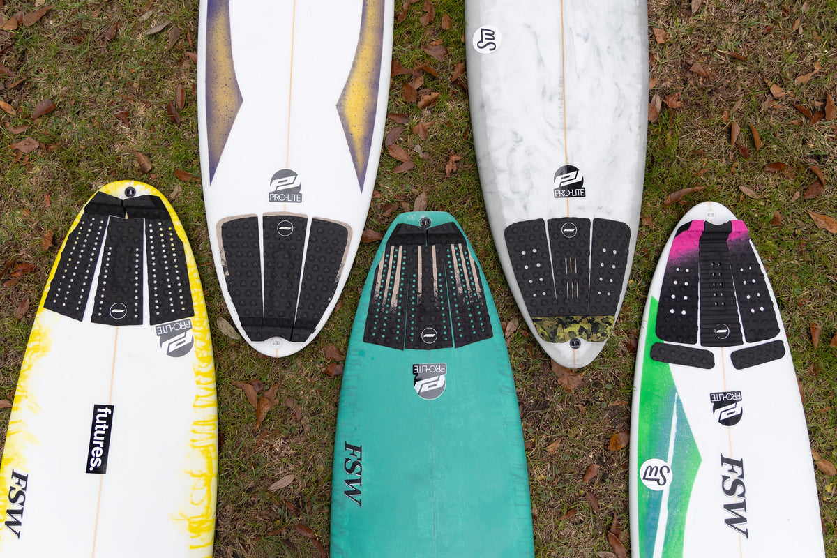 Pro-Lite surfboard traction pads displayed on boards.