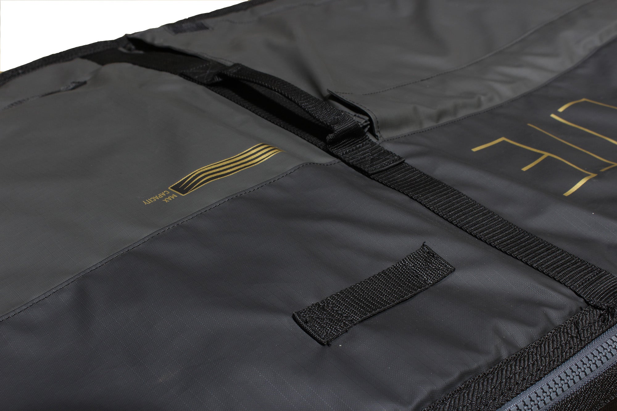 Pro-Lite finless coffin surfboard travel bag reinforced carry handles on top of bag.