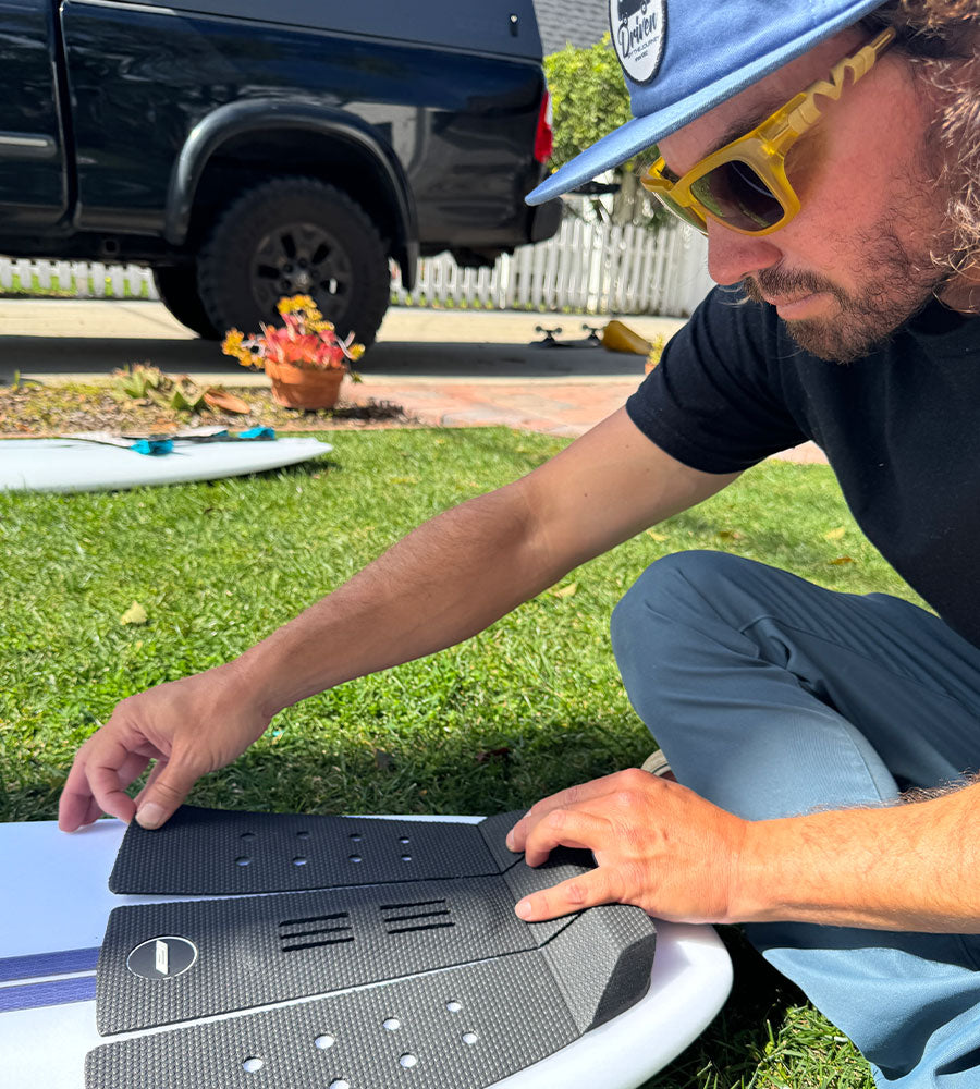 Timmy Reyes applies surf traction pad