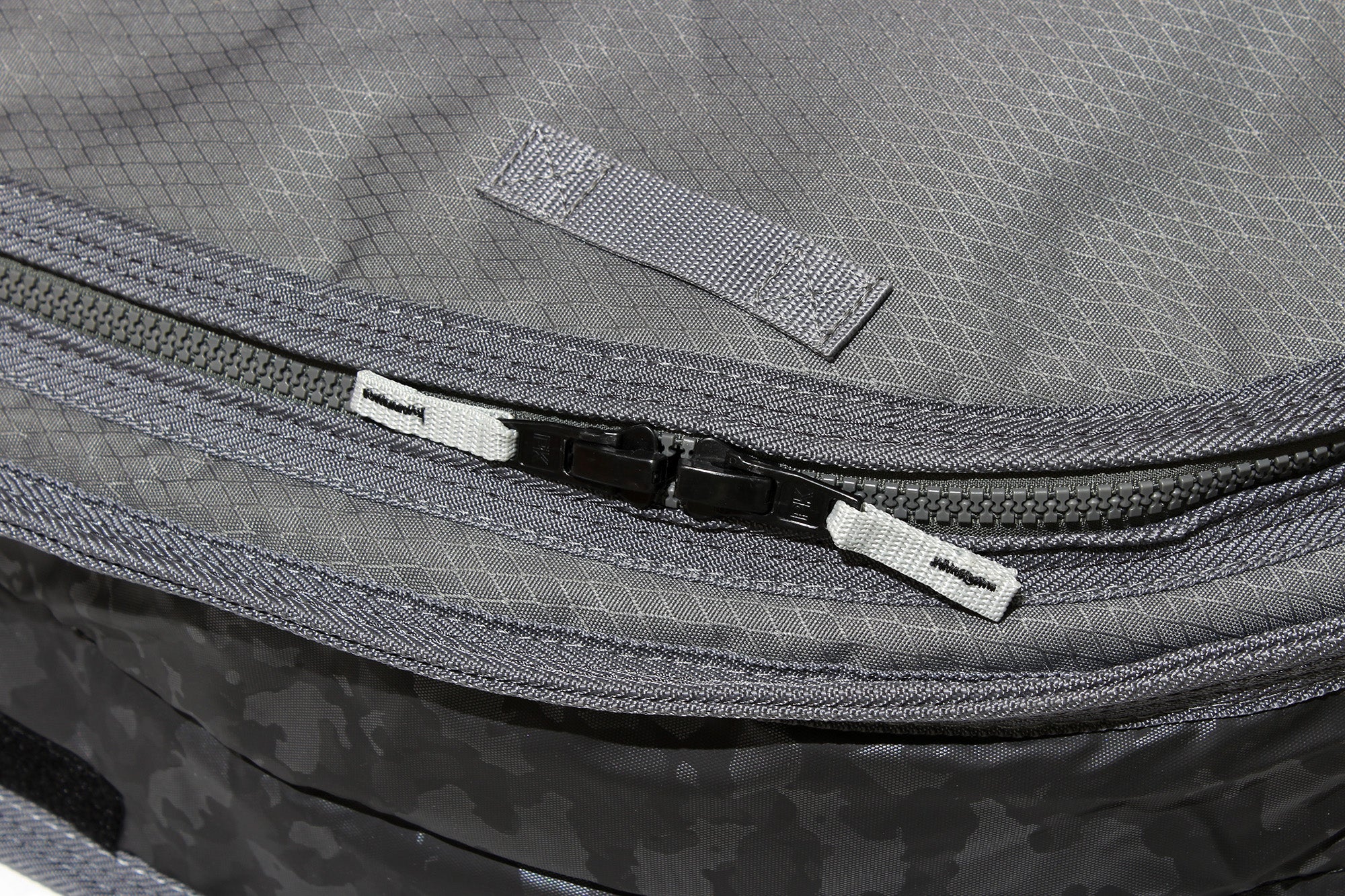 Close up of smuggler surf travel bag molded zippers