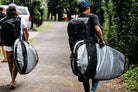 Surfers walk with the resession surfboard day bags.